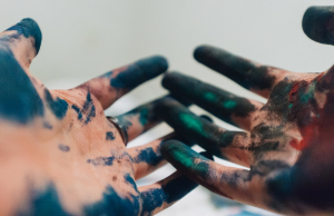 Hands covered with paint