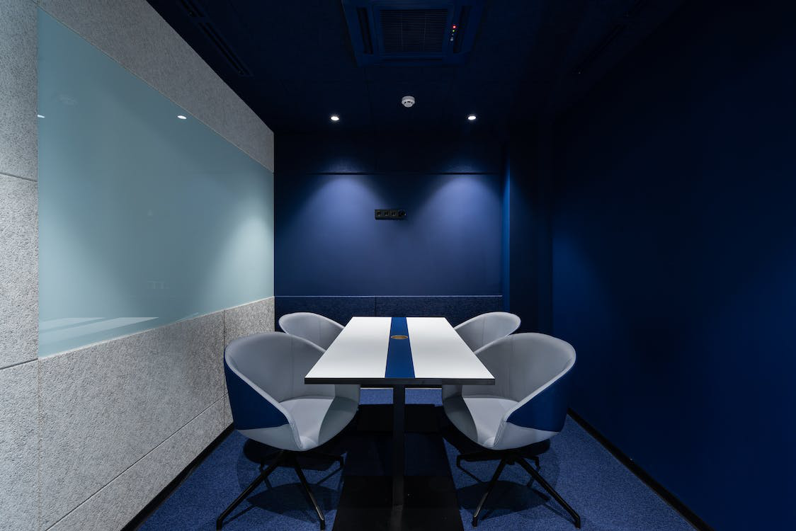 An office room with grey and blue colors.