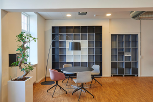An office space designed using hues of grey, white, and warm wood shades.