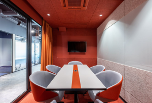 A white and tangerine-colored office space.