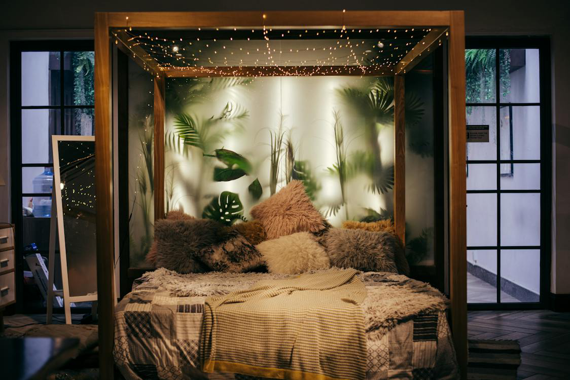 A nature-inspired bedroom with forest-themed interior painting and lighting