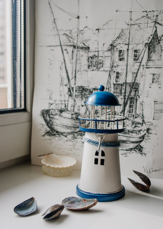 A serene seaside theme lighthouse and seashells for décor