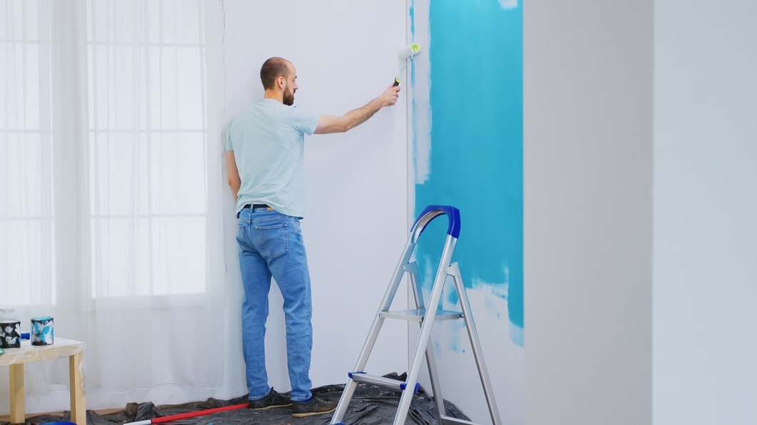 painting-blue-wall-with-white-paint-using-roller-brush-home-renovation-handyman-renovating-apartment-redecoration-home-construction-while-renovating-improving-repair-decorating_482257-14183