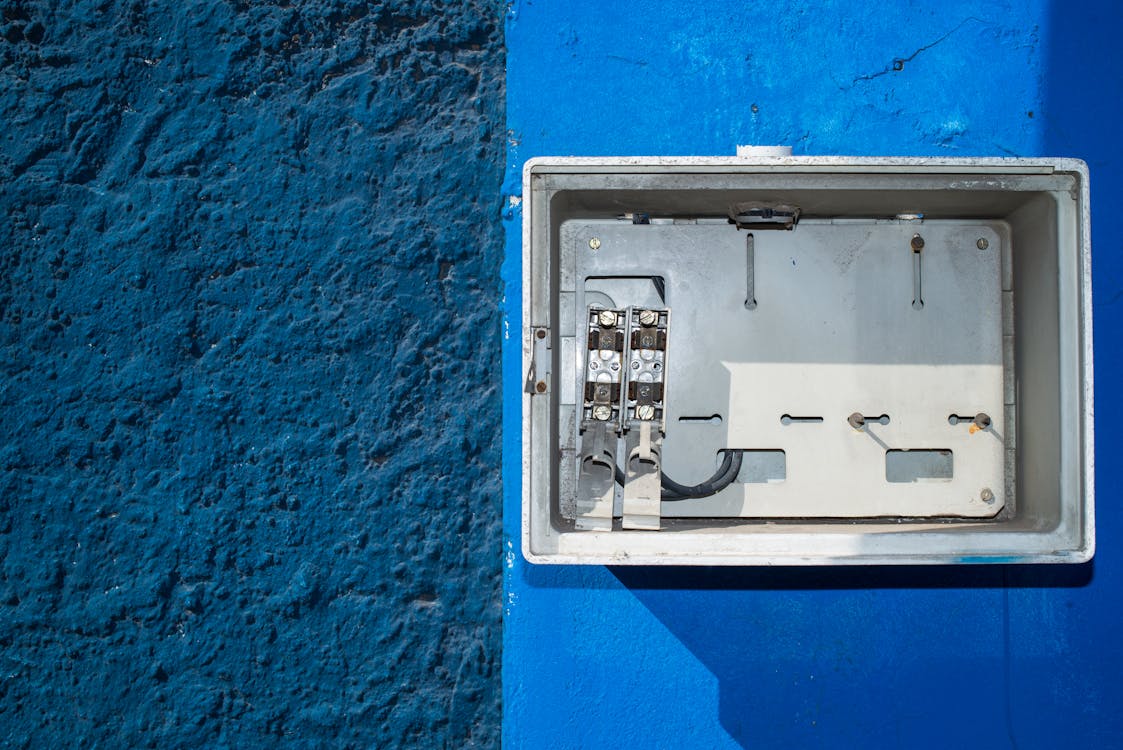 An electric box on a blue-painted wall