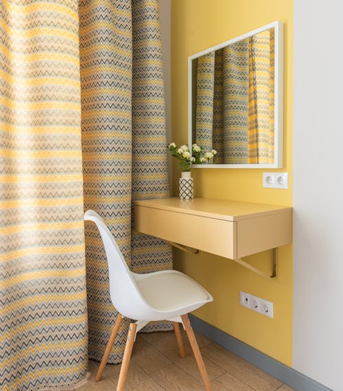 Interior of a room with warm earthy tones and ample natural light