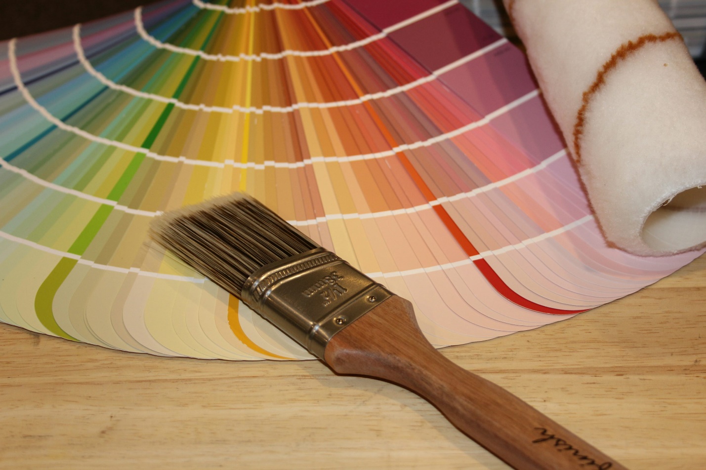 A paintbrush lying on a color fan deck