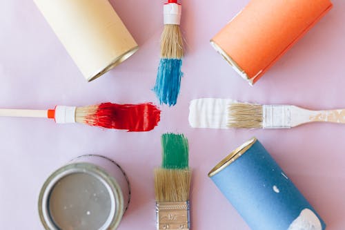 Paint buckets with brushes ready for seasonal painting projects to keep walls looking fresh and vibrant