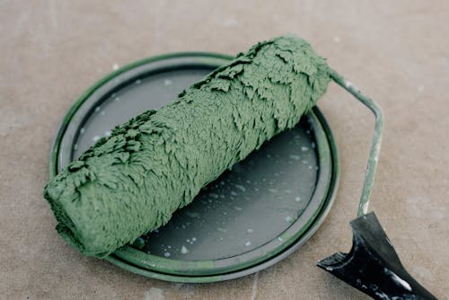 A paint roller resting on a lid, symbolizing proper painting tools