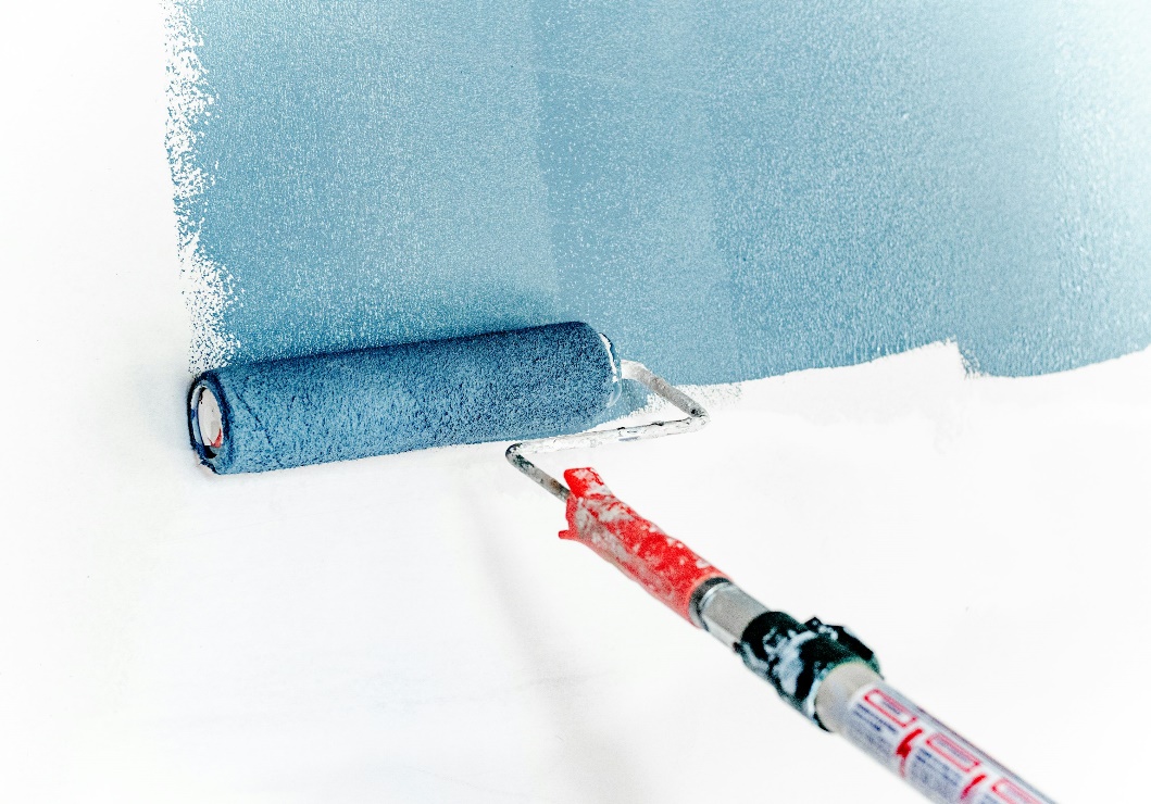 Paint roller loaded with blue paint