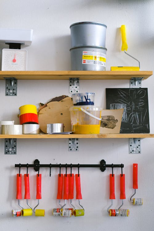 Set of painting equipment, including brushes, rollers, and paint cans