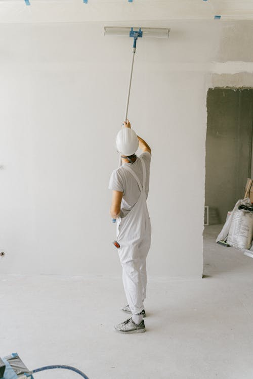 a painter with white overalls.