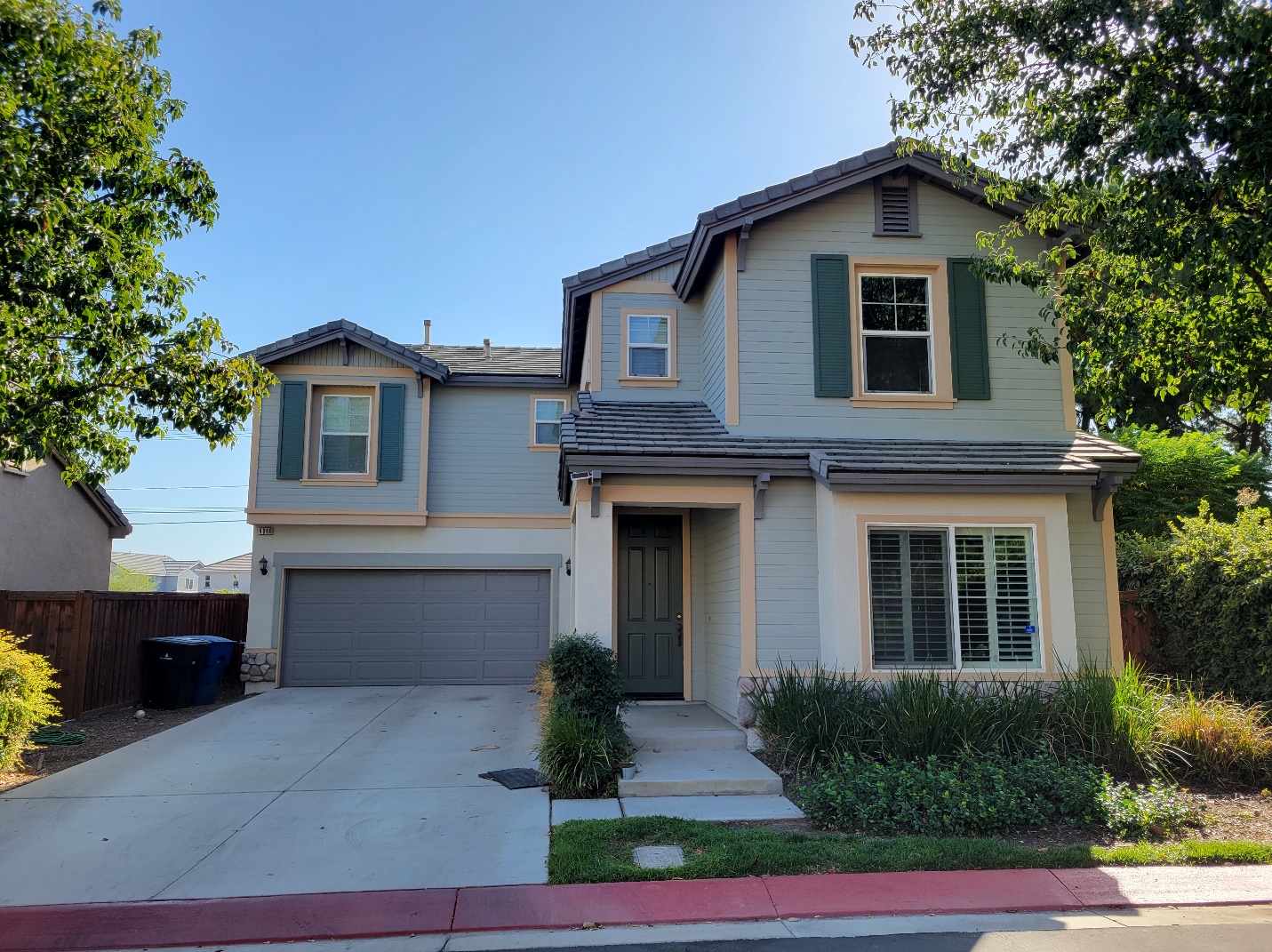 A freshly painted exterior of a house in a warm blue hue.