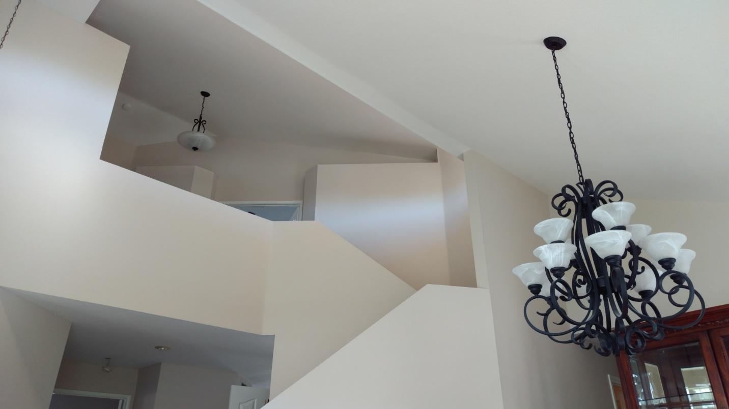 a chandelier hanging from a freshly painted ceiling