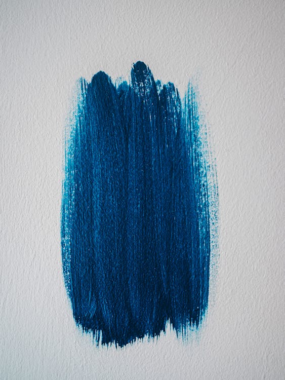 A splash of blue paint on a white wall, demonstrating the use of accent colors in interior painting.