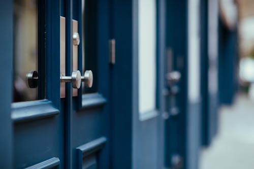 A close-up of freshly painted blue doors on a commercial building.