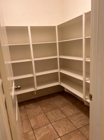 Freshly painted pantry featuring soft neutral tones, enhancing a modern and organized interior space.