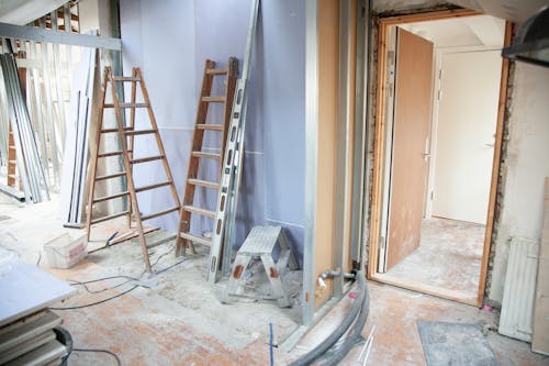 A room undergoing an interior painting project, with tools and fresh paint transforming the space.