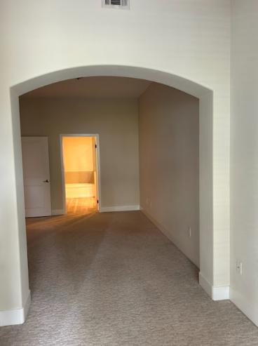 A freshly painted hallway with a vibrant new color, demonstrating the transformation of a home through interior painting.