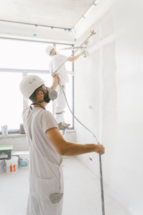 Professional painter applying a fresh coat of paint to the interior walls of a commercial property, enhancing its appearance.