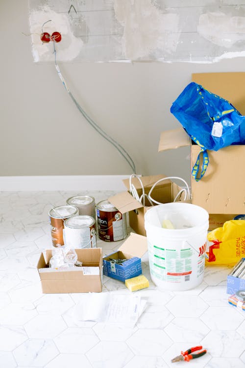 A collection of painting tools, including brushes, rollers, and trays, used for commercial and residential painting projects.