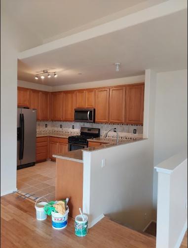 a kitchen space with wooden cabinetry.