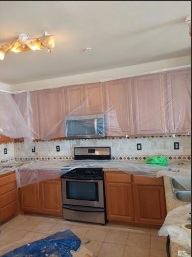 a kitchen space being prepped for painting.