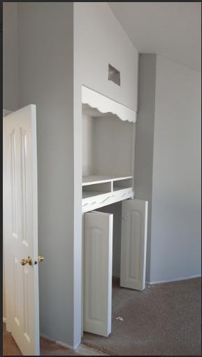 a room with white cabinets.