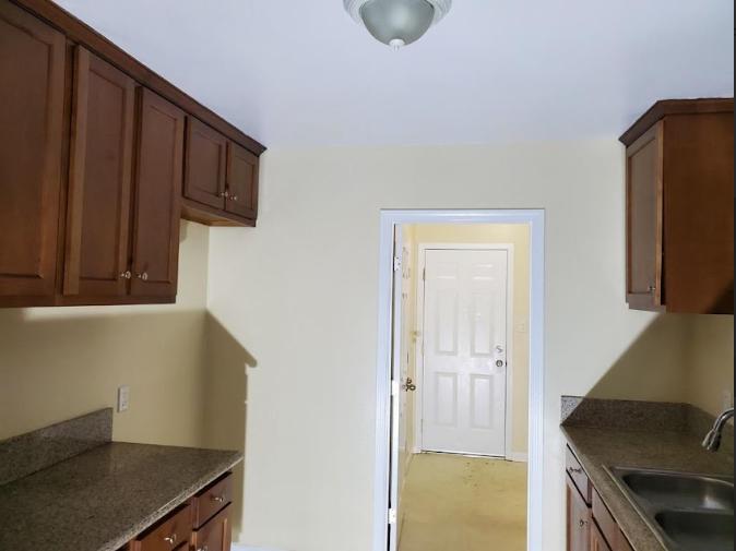 a kitchen space with wooden cabinetry.