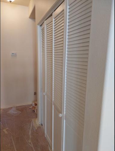 a room with white cupboards.