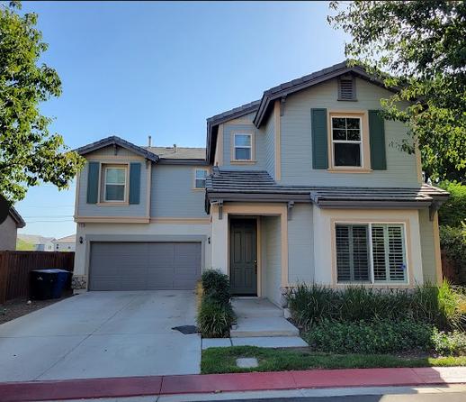 Ongoing exterior painting project with home painters applying light-colored paint to expand visual space.