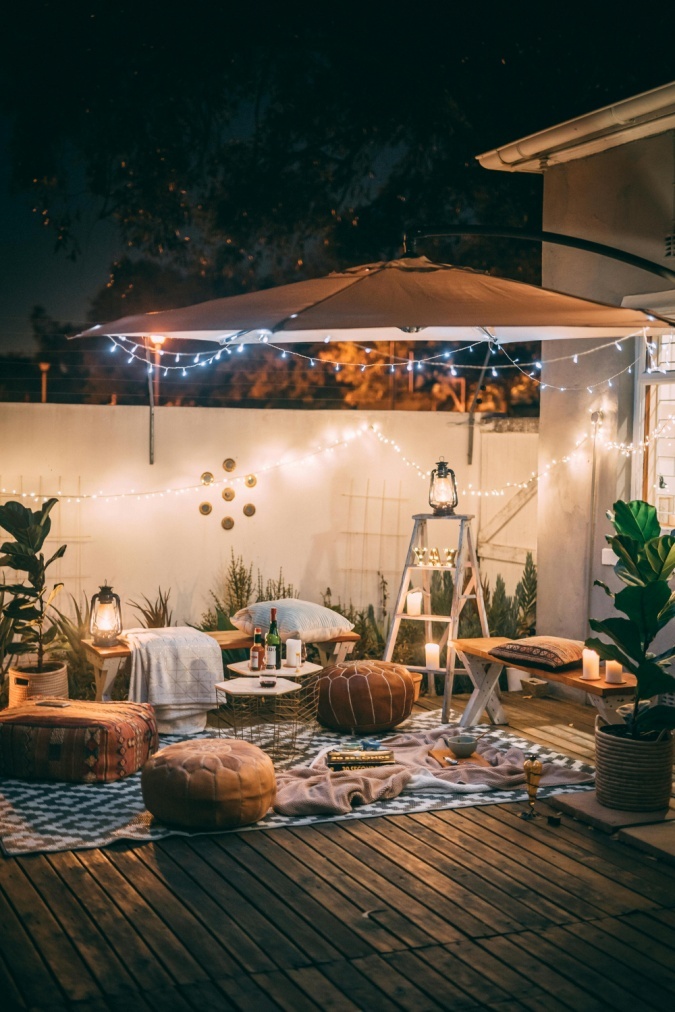 A patio with decor and a rug