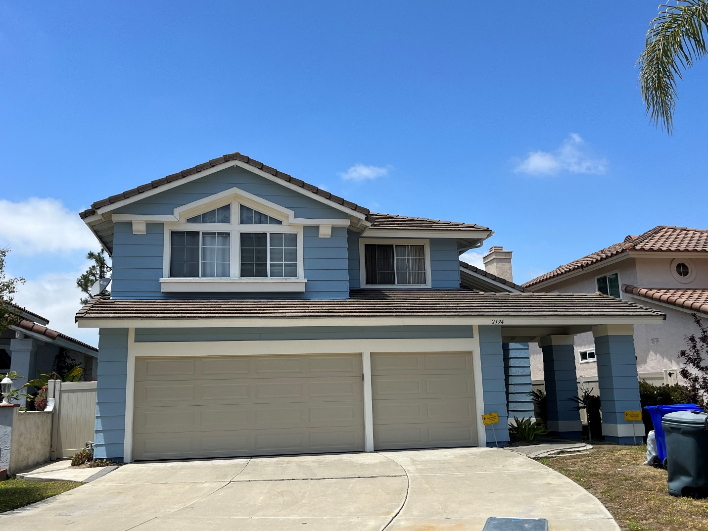 An after picture of the blue house with fresh paint