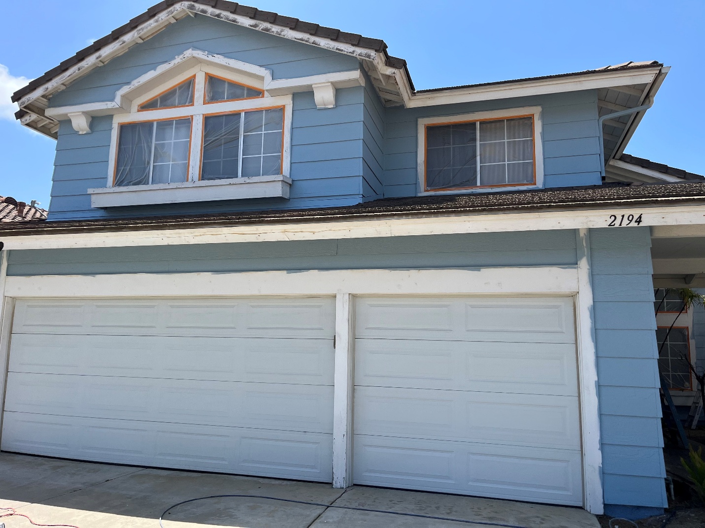 A before picture of a blue house with white accents
