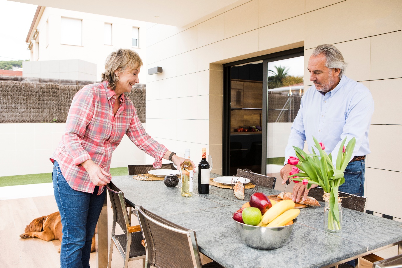 an elderly couple standing outdoors.