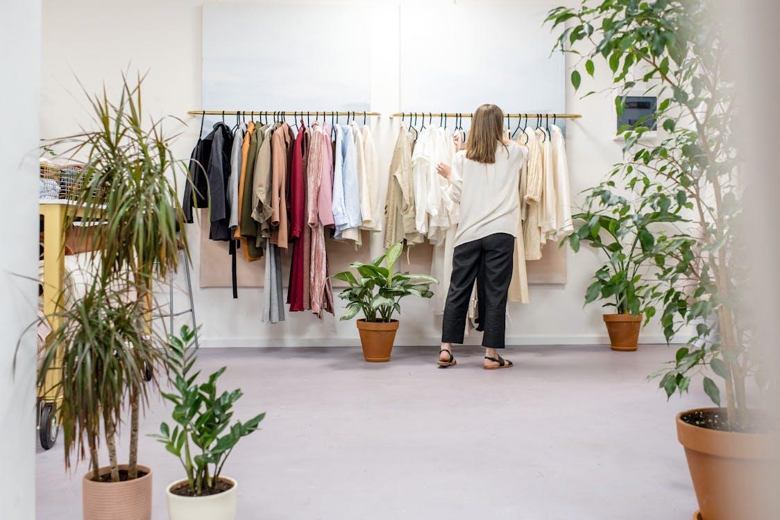 a woman in a white shirt at a store.