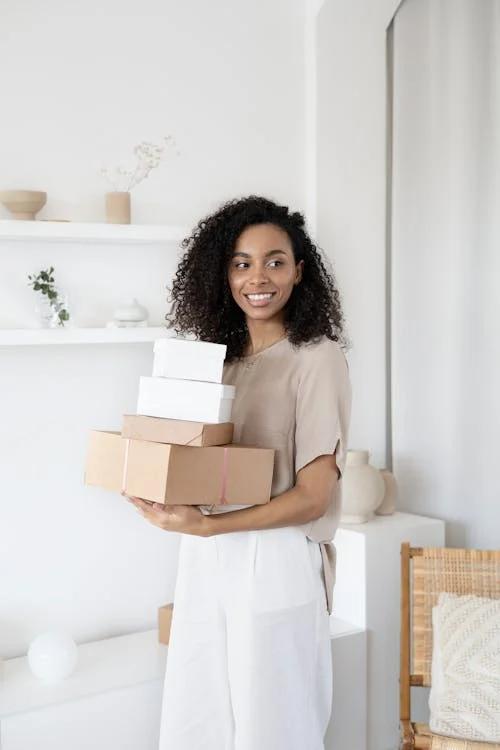 a woman carrying boxes.