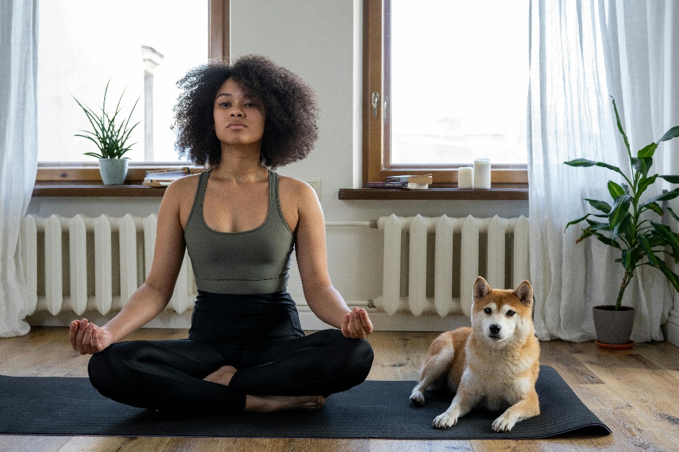 Woman meditating beside her dog 